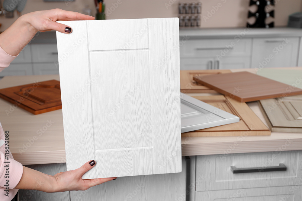Female hands holding sample of wooden panels for furniture and door Female hands holding sample of wooden panels for furniture and door