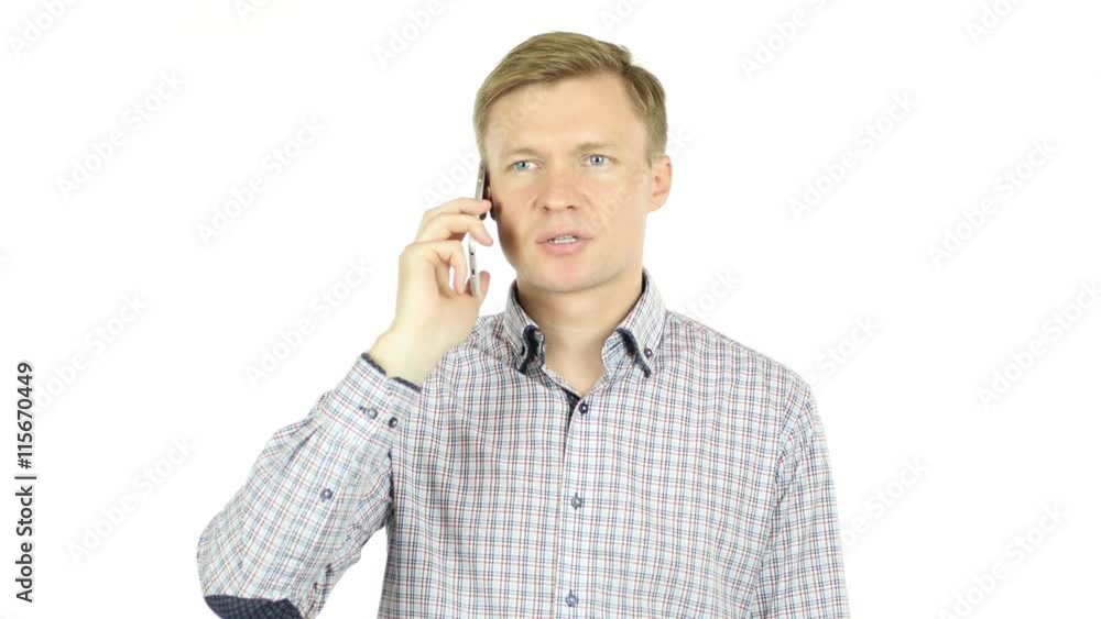 Man talking on a cell phone with a serious look of face Man talking on a cell phone with a serious look of face