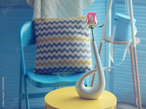 Beautiful rose on yellow table
