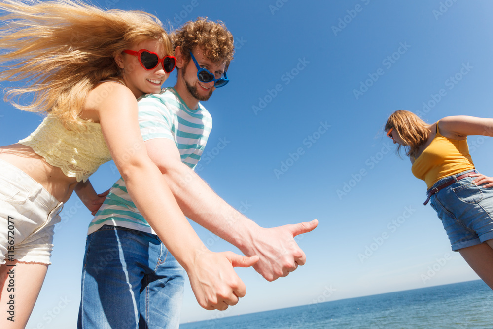 Couple friends showing thumb up gesture Couple friends showing thumb up gesture
