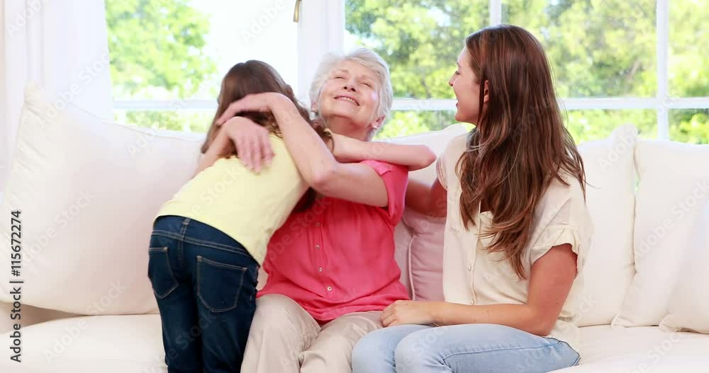 Cute child embracing grandmother and mother Cute child embracing grandmother and mother