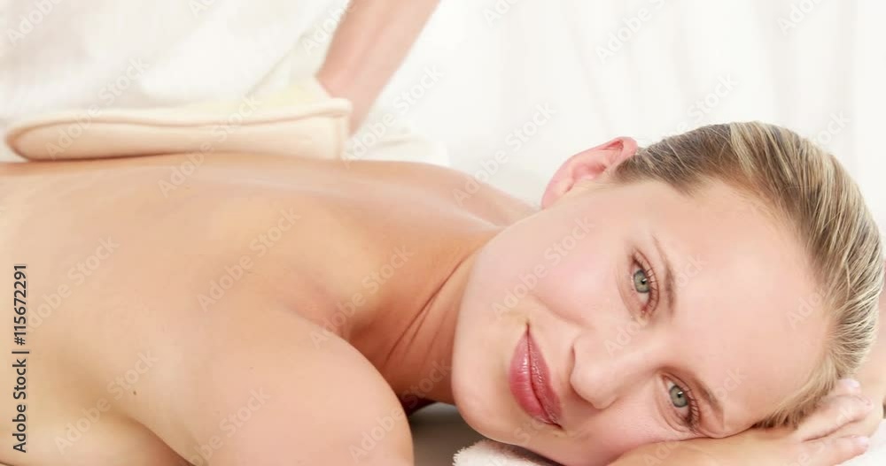 Therapist rubbing womans back with heated mitts in high quality 4k format Therapist rubbing womans back with heated mitts in high quality 4k format