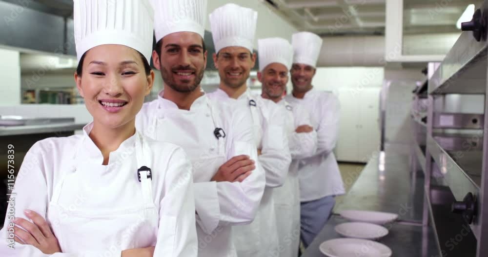 Smiling chefs standing in a line Smiling chefs standing in a line