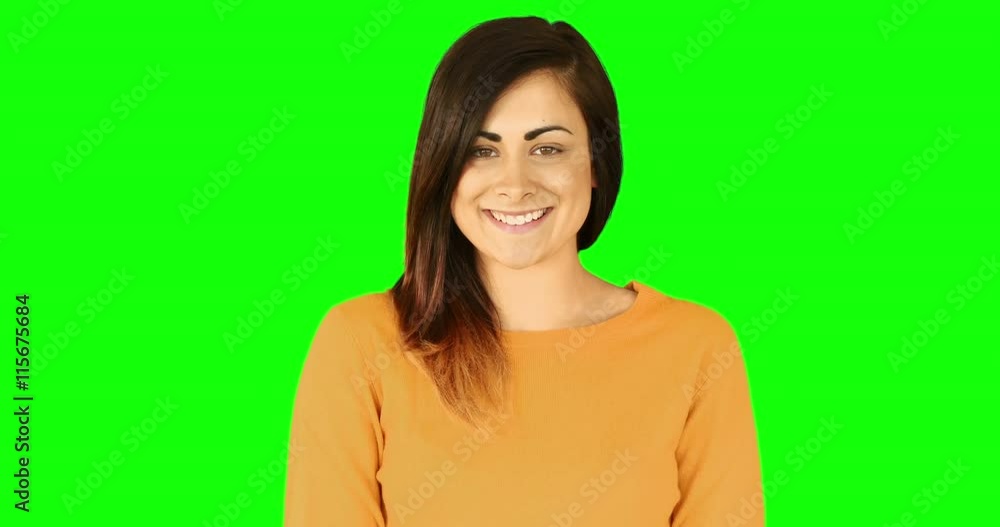 Happy brunette blowing over hands on green screen Happy brunette blowing over hands on green screen