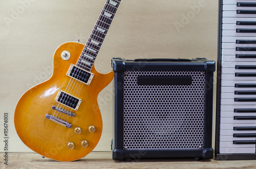 Electric guitar and amplifier isolated on a  light brown photo