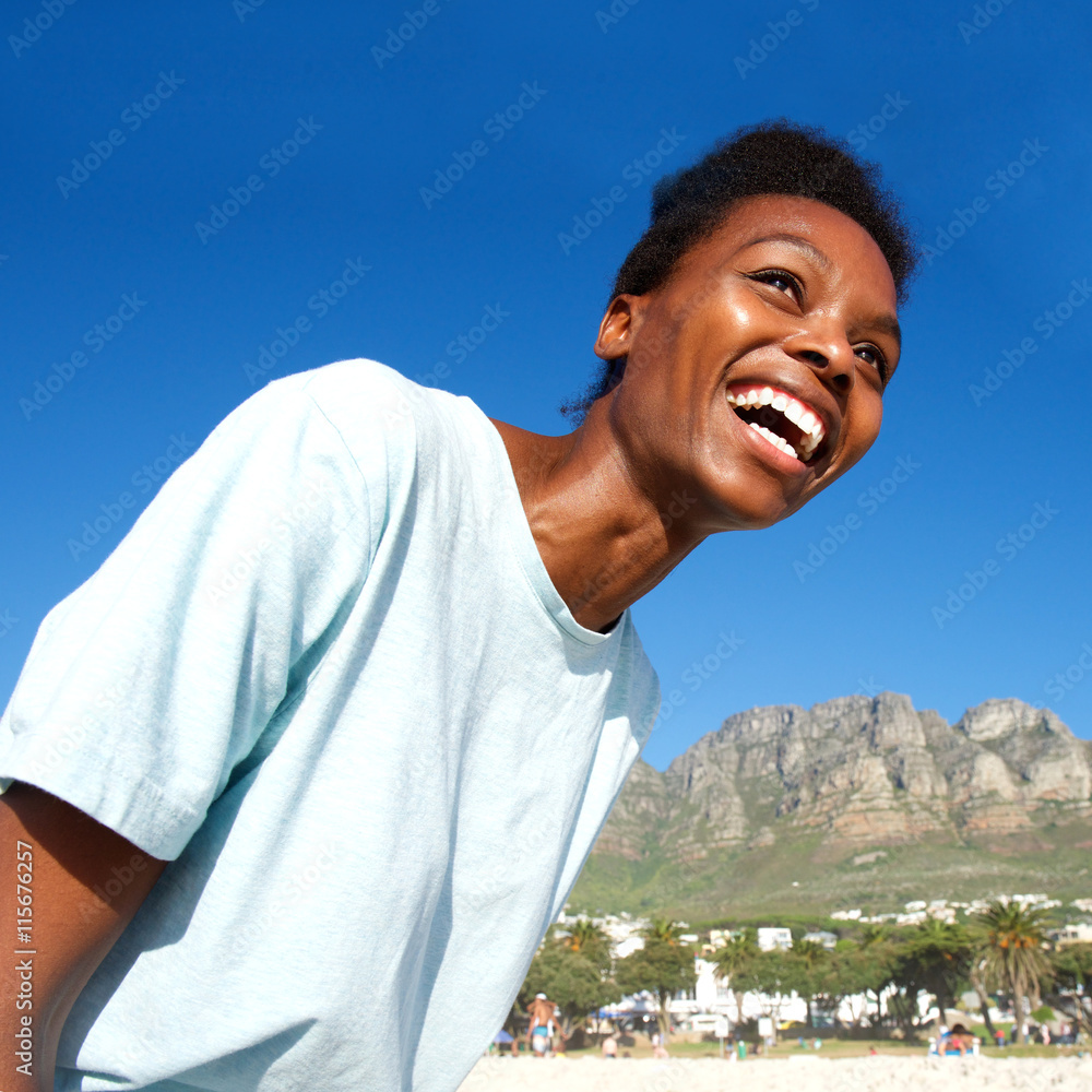 Cheerful young african lady standing outdoors Cheerful young african lady standing outdoors