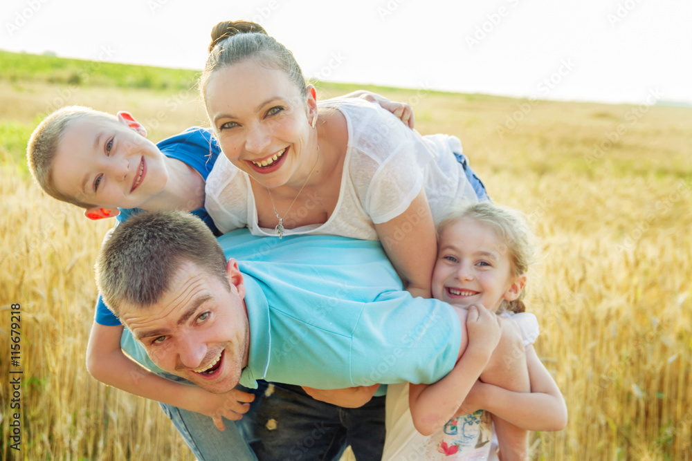 Family having fun in wheat field