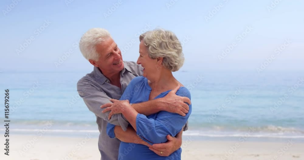 Old couple hugging and dancing at the beach Old couple hugging and dancing at the beach