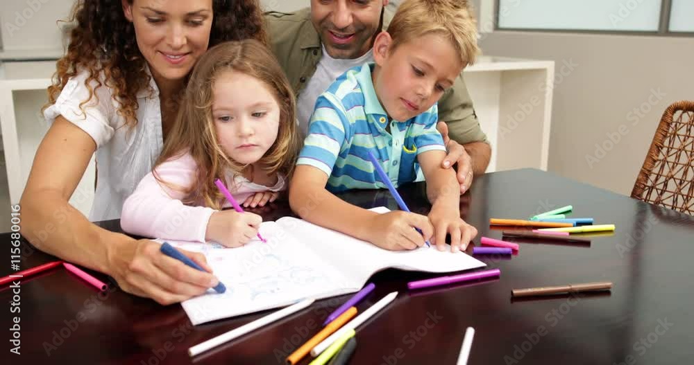 Cute children drawing at the table with their parents Cute children drawing at the table with their parents