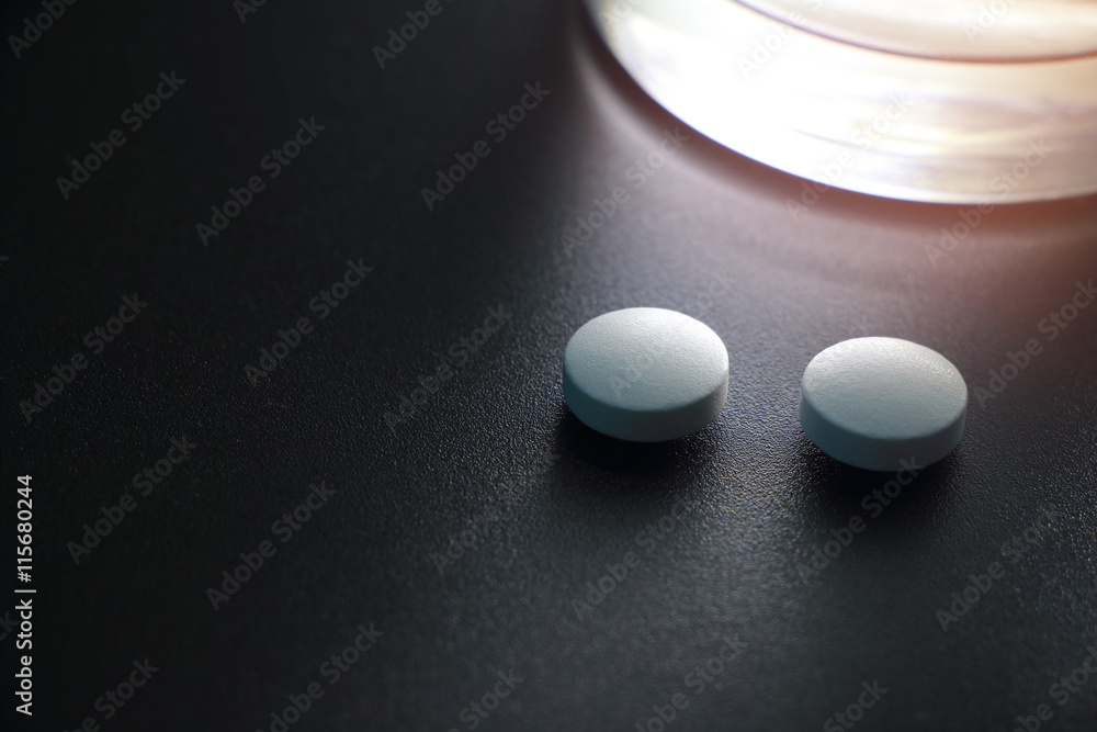 white pills on black background, insomnia white pills on black background, insomnia