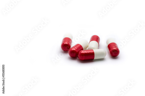 Red and white capsules on white background