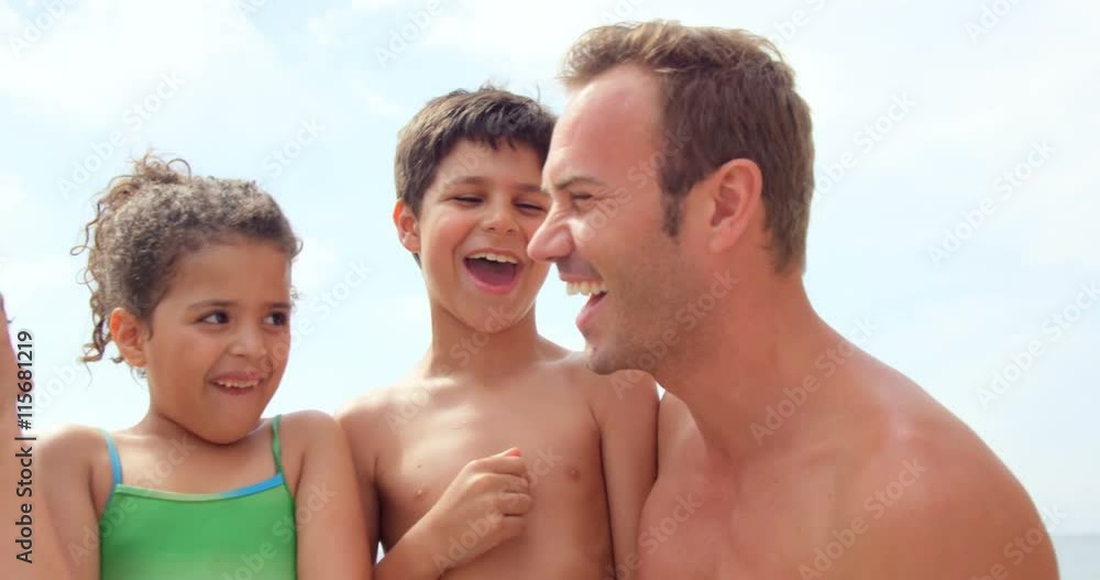 Happy family standing together on the beach Happy family standing together on the beach