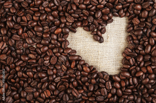 Plenty of coffee beans and texture heart shape background love s
