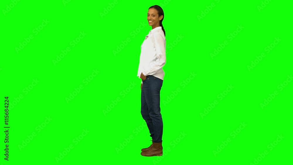 Casual woman smiling at camera on green screen background Casual woman smiling at camera on green screen background