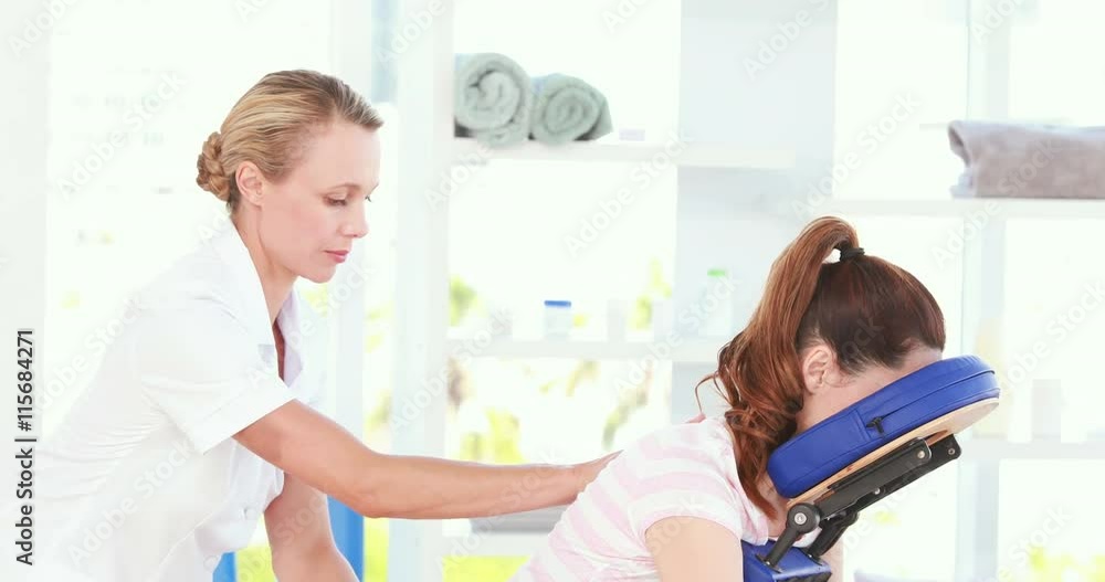 Physiotherapist doing back massage to her patient Physiotherapist doing back massage to her patient
