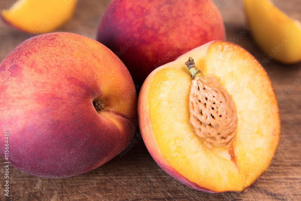 Fresh peaches on a wooden cutting board. Fresh peaches on a wooden cutting board.