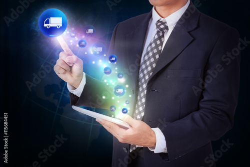 Businessman holding tablet with pressing delivery sign icon button. internet and networking concept