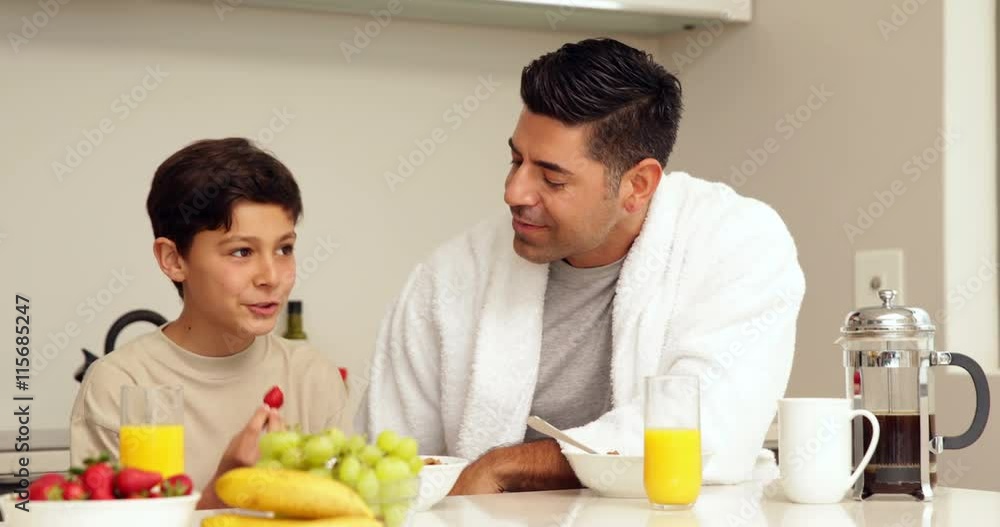 Handsome man having breakfast with his son Handsome man having breakfast with his son