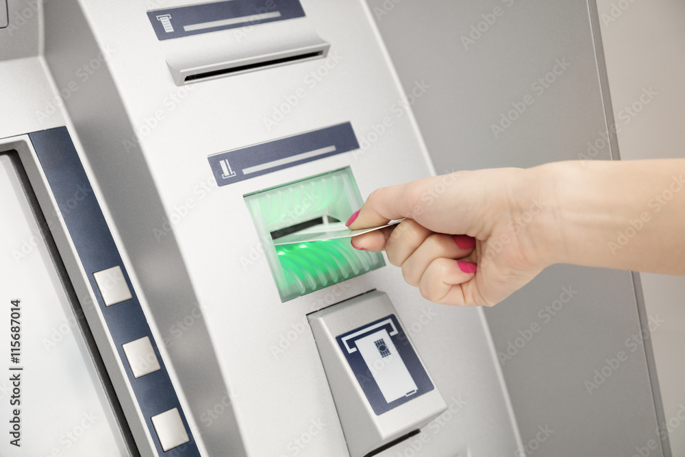 Using ATM machine. Using ATM machine.