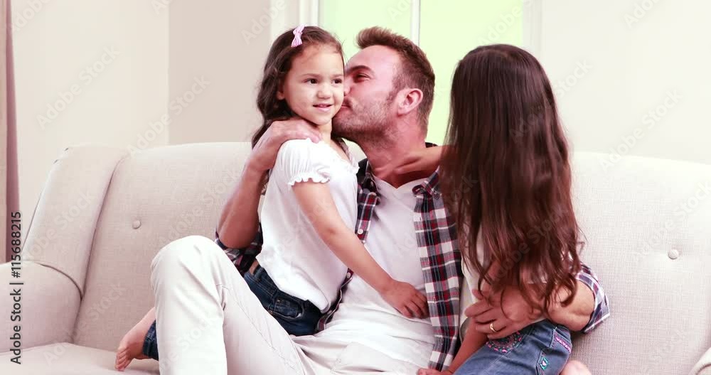 Happy father hugging his daughters Happy father hugging his daughters