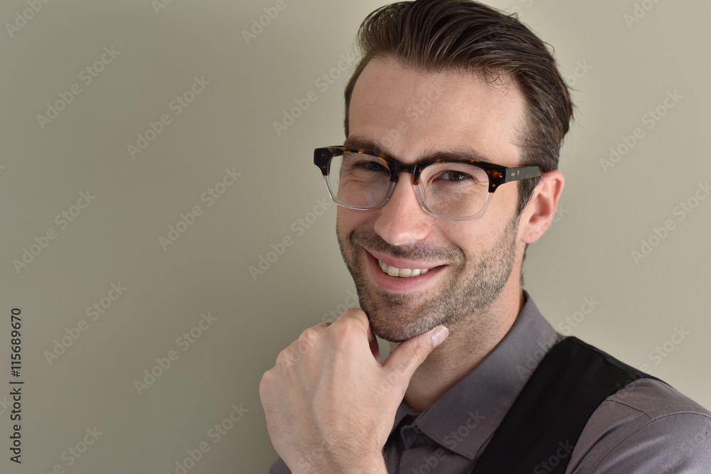 Stylish guy with eyeglasses on beige background Stylish guy with eyeglasses on beige background