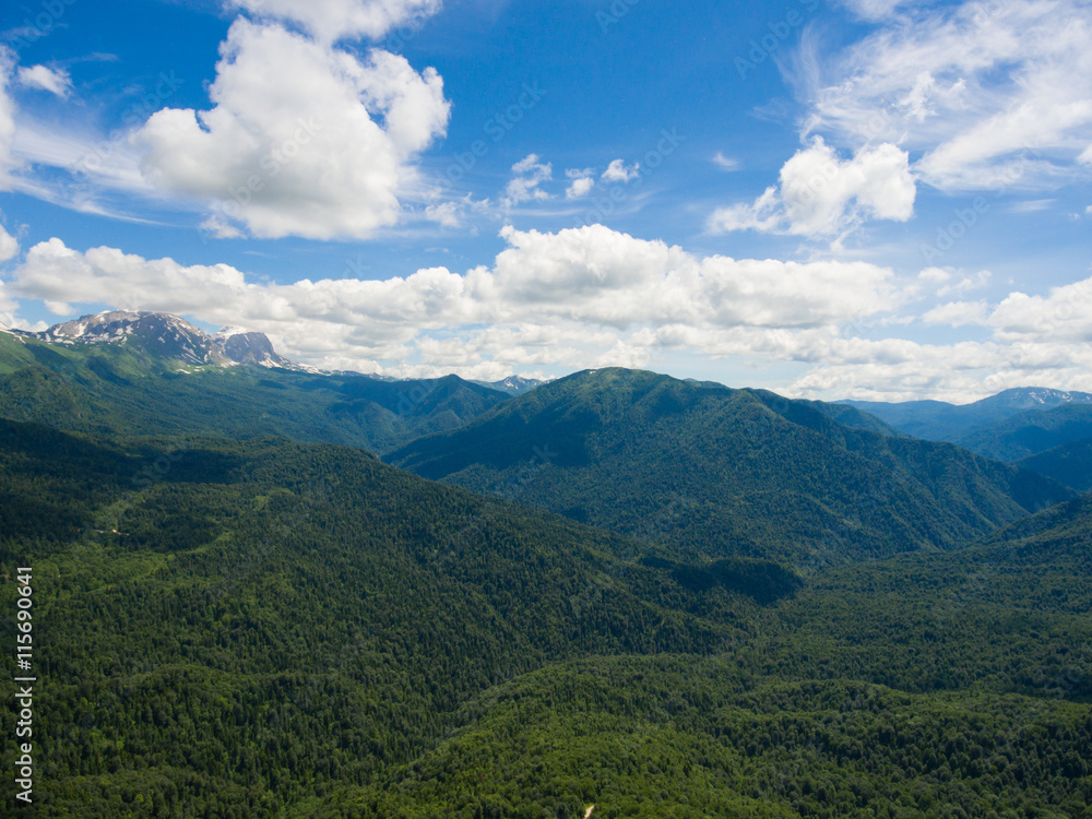 Aerial photo. Mountain valley. Landscape with mountain peaks cov Aerial photo. Mountain valley. Landscape with mountain peaks cov