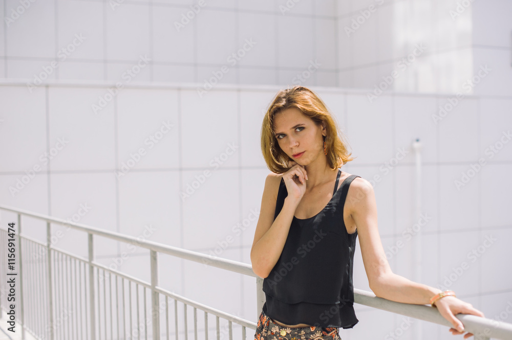beautiful slim girl in shorts and t-shirt standing on bolkone looking into the distance beautiful slim girl in shorts and t-shirt standing on bolkone looking into the distance