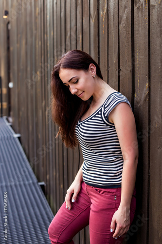 Portrait of positive woman on a wooden background