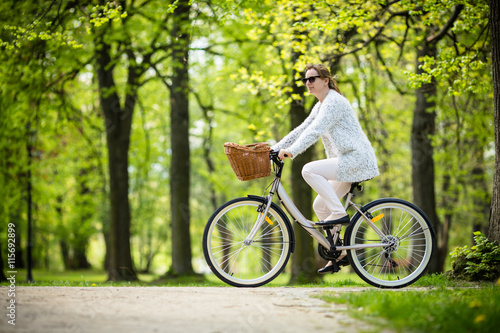 Urban biking - woman riding bike in city park  © Jacek Chabraszewski