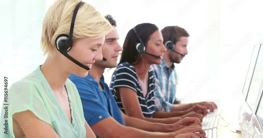 Happy call centre agents talking on the headset Happy call centre agents talking on the headset