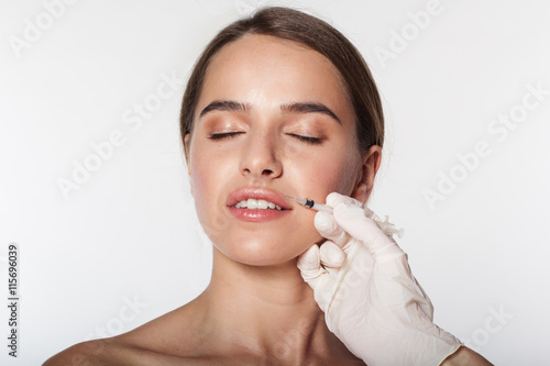 Girl getting beauty injection to lips