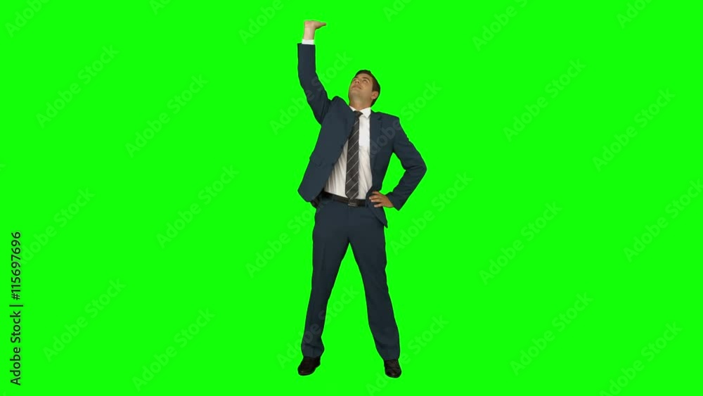 Businessman standing with hand raised on green screen background Businessman standing with hand raised on green screen background