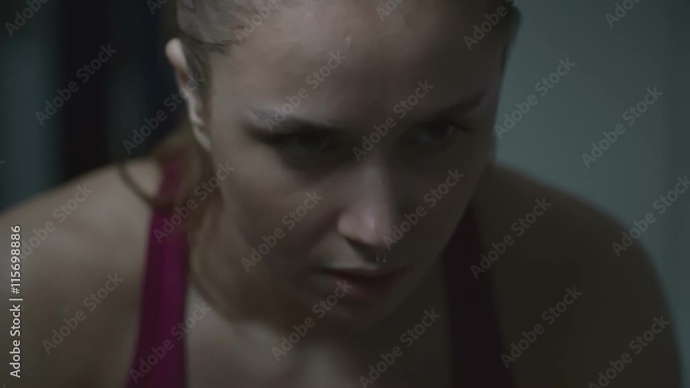 Slow motion shot of young woman with sweat dripping off her nose after exhausting workout Slow motion shot of young woman with sweat dripping off her nose after exhausting workout