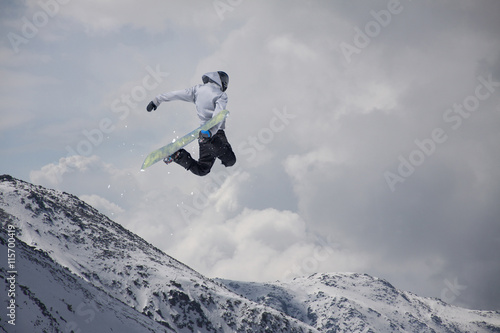 Snowboard rider jumping on mountains. Extreme snowboard freeride sport. © Vasily Merkushev