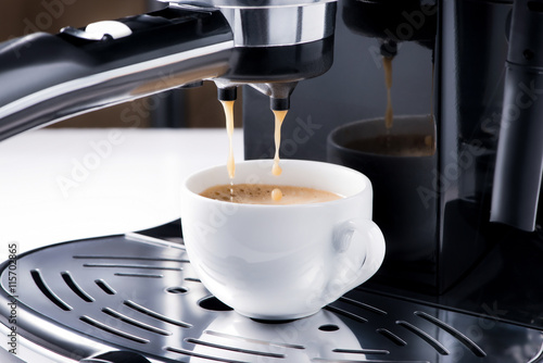 Close-up of espresso pouring from coffee machine. Preparation fo