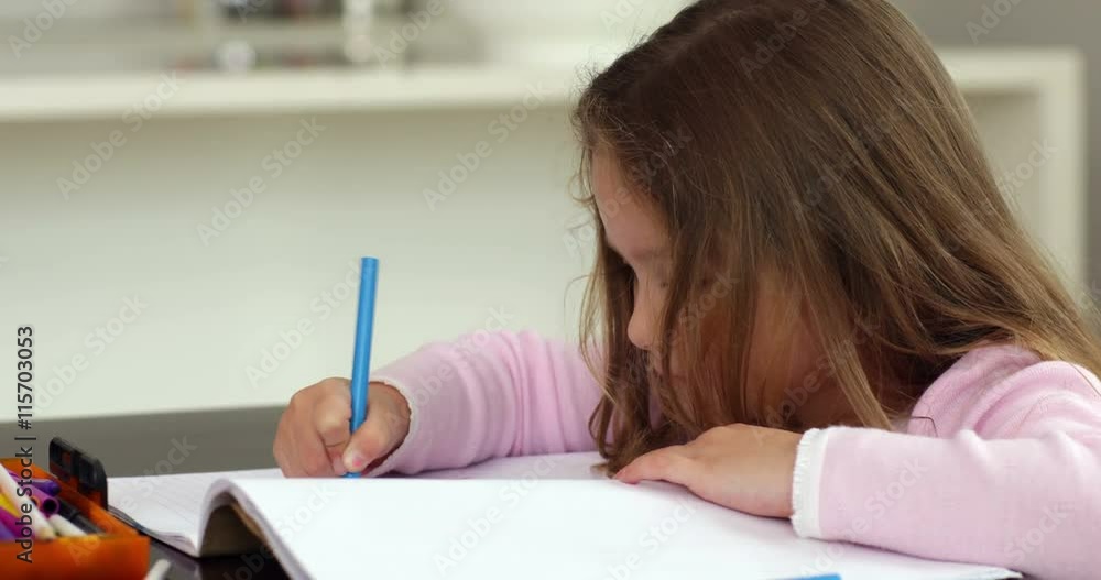 Little girl drawing at the kitchen table Little girl drawing at the kitchen table