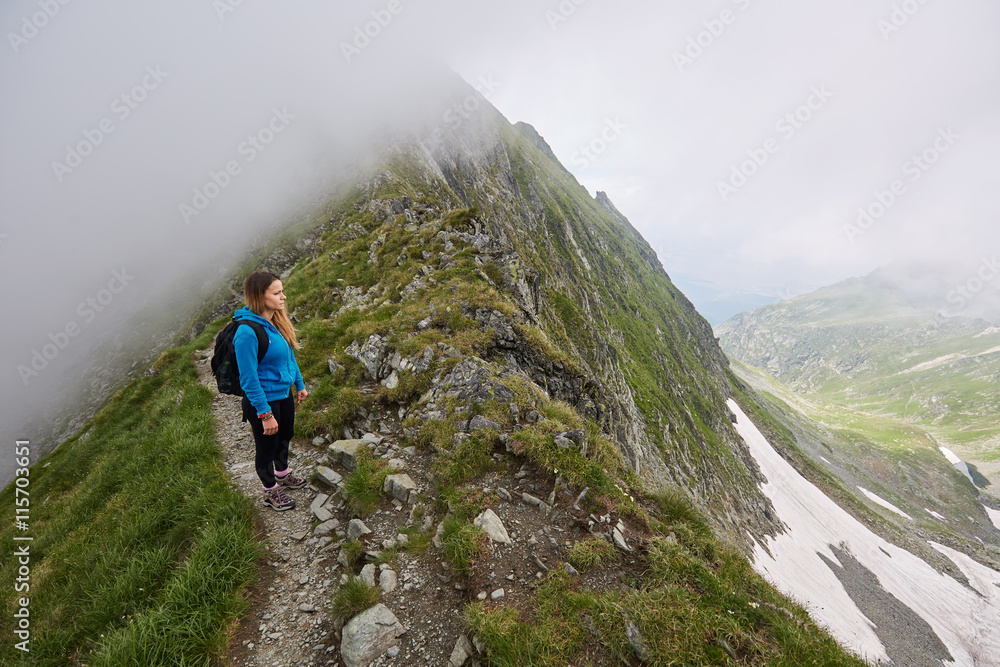 Woman backpacker hiking on a trail