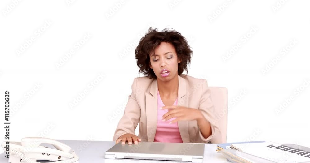 Businesswoman feeling stressed at her desk on white background Businesswoman feeling stressed at her desk on white background