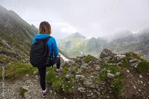 Woman backpacker hiking on a trail © Xalanx