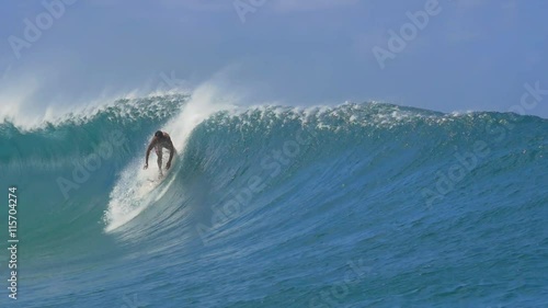 SLOW MOTION: Extreme pro surfer surfing big tube barrel wave