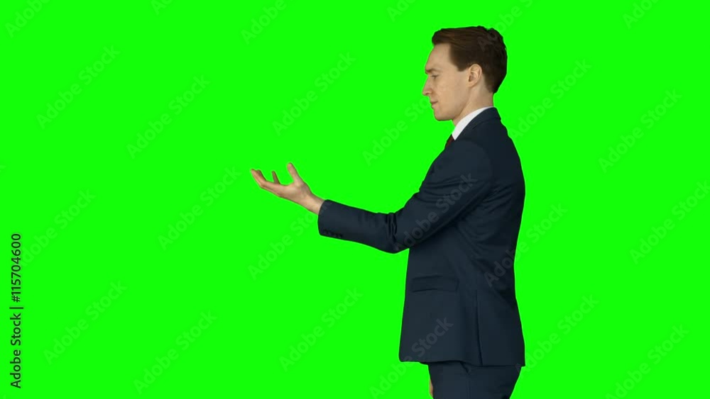 Businessman lifting something on his hand on green screen Businessman lifting something on his hand on green screen