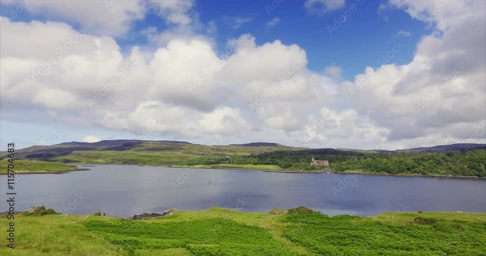 Views of Dunvegan Castle from Uiginish, green summer meadows and the blue water of Loch Dunvegan Views of Dunvegan Castle from Uiginish, green summer meadows and the blue water of Loch Dunvegan