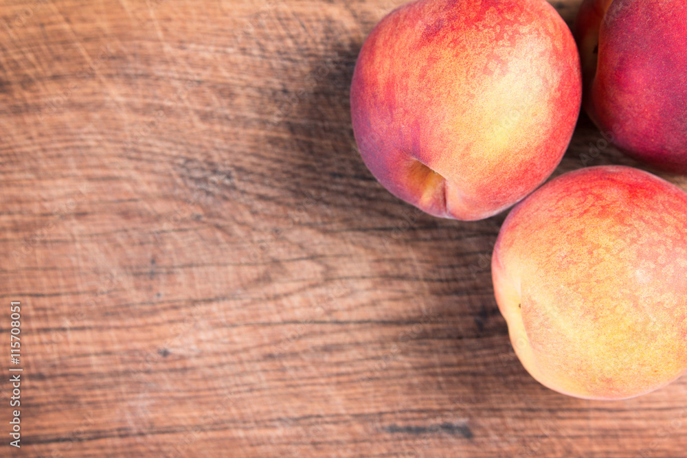 Fresh peaches on a wooden cutting board. Fresh peaches on a wooden cutting board.