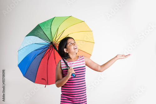 Photography Indian small girl with multicolored umbrella, isolated over white