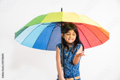 Photography Indian small girl with multicolored umbrella, isolated over white