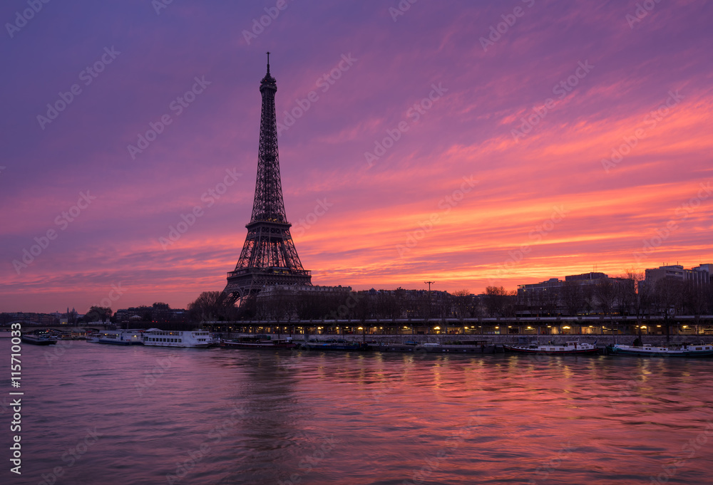 Fiery sunrise on the Eiffel Tower and Seine River in winter. Port de Suffren, Grenelle, 15th and 7th Arrondissements of Paris, France