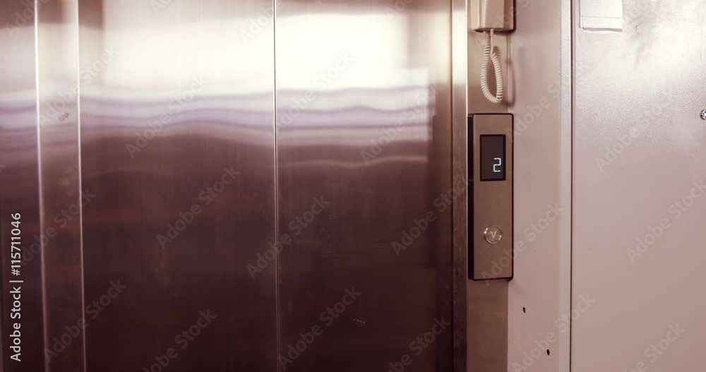Serious businessman coming out of the elevator in office Serious businessman coming out of the elevator in office