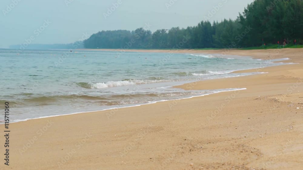 Gentle waves and sea foam wash over the coarse sand of a pristine, tropical beach paradise on a cloudy day. Video UltraHD Gentle waves and sea foam wash over the coarse sand of a pristine, tropical beach paradise on a cloudy day. Video UltraHD