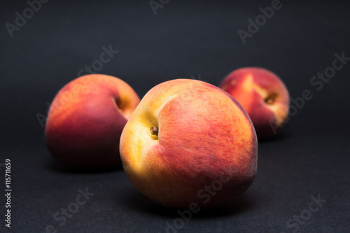 Close up shot of fresh peaches on a black background