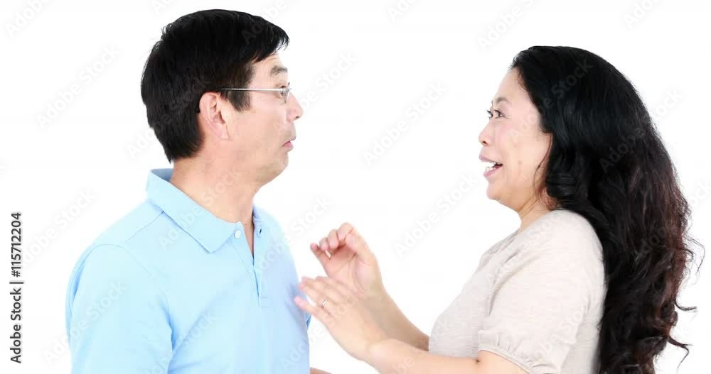 Mature Asian couple telling secrets to each other on white screen Mature Asian couple telling secrets to each other on white screen